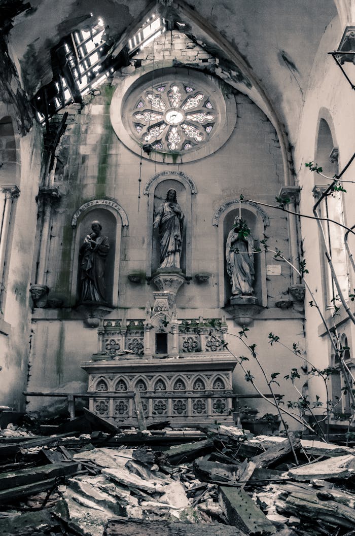 Captivating view of an abandoned church altar with religious statues and dilapidated surroundings.